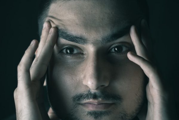 a man with his hands on his face
